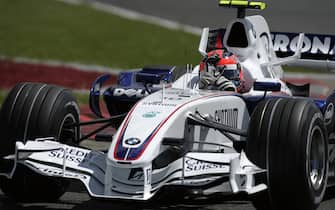 877385060 Robert Kubica, BMW Sauber F1.07, Grand Prix of Great Britain, Silverstone Circuit, 08 July 2007. Robert Kubica waves at the crowd during his slowing down after qualifying for the 2007 British Grand Prix. (Photo by Paul-Henri Cahier/Getty Images)