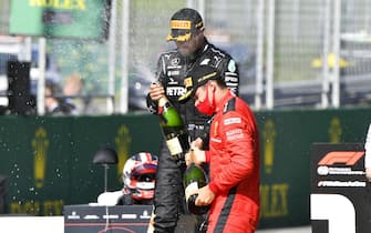 JULY 05: Race winner Valtteri Bottas, Mercedes-AMG Petronas F1 and Charles Leclerc, Ferrari celebrate with the champagne during the Austrian GP on Sunday July 05, 2020. (Photo by Mark Sutton / Sutton Images)