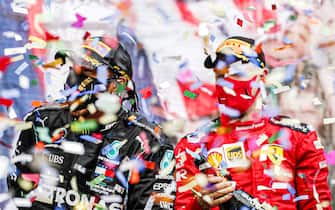 ISTANBUL PARK, TURKEY - NOVEMBER 15: Lewis Hamilton, Mercedes-AMG Petronas F1, 1st position, and Sebastian Vettel, Ferrari, 3rd position, celebrate with Champagne on the podium during the Turkish GP at Istanbul Park on Sunday November 15, 2020, Turkey. (Photo by Steven Tee / LAT Images)