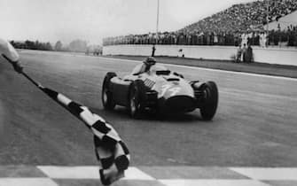 BUENOS AIRES, ARGENTINA - JANUARY22:  Lancia-Ferrari D50 driver Juan Manuel Fangio crosses the finish line of the Argentina's Grand Prix and wins 22 January 1956 in Buenos Aires .  AFP PHOTO  (Photo credit should read STF/AFP/Getty Images)