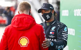 NÃ¼RBURGRING, GERMANY - OCTOBER 11: Mick Schumacher congratulates Lewis Hamilton, Mercedes-AMG Petronas F1, 1st position, on equalling his fathers race win record of 91 during the Eifel GP at NÃ¼rburgring on Sunday October 11, 2020, Germany. (Photo by Andy Hone / LAT Images)