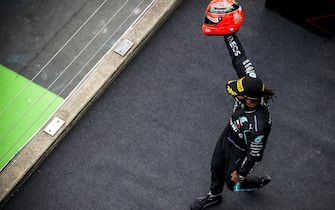 NÃ¼RBURGRING, GERMANY - OCTOBER 11: Lewis Hamilton, Mercedes-AMG Petronas F1, 1st position, arrives on the podium with the helmet of Michael Schumacher that was presented to him by Mick Schumacher during the Eifel GP at NÃ¼rburgring on Sunday October 11, 2020, Germany. (Photo by Zak Mauger / LAT Images)