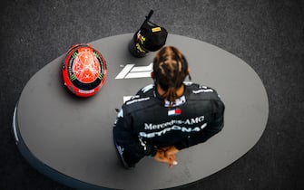 NÃ¼RBURGRING, GERMANY - OCTOBER 11: Lewis Hamilton, Mercedes-AMG Petronas F1, 1st position, on the podium with his trophy and the helmet of Michael Schumacher during the Eifel GP at NÃ¼rburgring on Sunday October 11, 2020, Germany. (Photo by Zak Mauger / LAT Images)