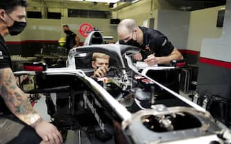 BAHRAIN INTERNATIONAL CIRCUIT, BAHRAIN - DECEMBER 02: Mick Schumacher sits in his Haas VF-20 for his seat fitting with race engineer Gary Gannon during the Sakhir GP at Bahrain International Circuit on Wednesday December 02, 2020 in Sakhir, Bahrain. (Photo by Andy Hone / LAT Images)