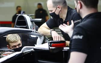 BAHRAIN INTERNATIONAL CIRCUIT, BAHRAIN - DECEMBER 02: Mick Schumacher sits in his Haas VF-20 for his seat fitting with race engineer Gary Gannon during the Sakhir GP at Bahrain International Circuit on Wednesday December 02, 2020 in Sakhir, Bahrain. (Photo by Andy Hone / LAT Images)