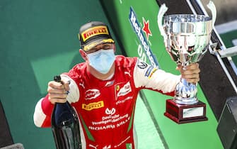 AUTODROMO NAZIONALE MONZA, ITALY - SEPTEMBER 05: Race Winner Mick Schumacher (DEU, PREMA RACING) celebrates on the podium with the champagne and the trophy at Autodromo Nazionale Monza on Saturday September 05, 2020 in Monza, Italy. (Photo by Charles Coates / LAT Images)