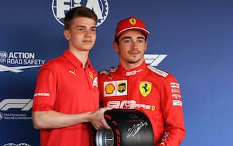 SOCHI AUTODROM, RUSSIAN FEDERATION - SEPTEMBER 28: F3 racer Marcus Armstrong presents Charles Leclerc, Ferrari, with the Pirelli Pole Position Award during the Russian GP at Sochi Autodrom on September 28, 2019 in Sochi Autodrom, Russian Federation. (Photo by Mark Sutton / Sutton Images)