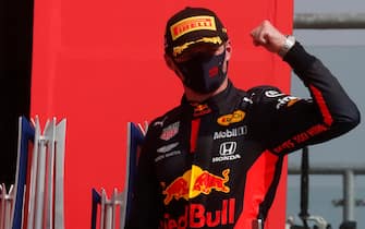 TOPSHOT - Red Bull's Dutch driver Max Verstappen celebrates on the podium after winning the F1 70th Anniversary Grand Prix at Silverstone on August 9, 2020 in Northampton. - The race commemorates the 70th anniversary of the inaugural world championship race, held at Silverstone in 1950. (Photo by Frank Augstein / POOL / AFP) (Photo by FRANK AUGSTEIN/POOL/AFP via Getty Images)