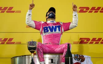 Racing Point's Mexican driver Sergio Perez celebrates on the podium after winning the Sakhir Formula One Grand Prix at the Bahrain International Circuit in the city of Sakhir on December 6, 2020. - Mexican Sergio Perez claimed his maiden Formula One victory in a dramatic Sakhir Grand Prix in Bahrain on Sunday. The Racing Point driver, 30, won for the first time in his 194th race. (Photo by Bryn Lennon / POOL / AFP) (Photo by BRYN LENNON/POOL/AFP via Getty Images)