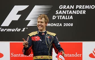 MONZA, ITALY - SEPTEMBER 14:  Sebastian Vettel of Germany and Scuderia Toro Rosso celebrates on the podium after winning the Italian Formula One Grand Prix at the Autodromo Nazionale di Monza on September 14, 2008 in Monza, Italy.  (Photo by Peter Fox/Getty Images)