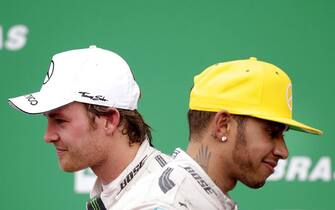 epa05656487 (FILE) A file picture dated 15 November 2015 of German Formula One driver Nico Rosberg (L) of Mercedes and his second placed British team mate Lewis Hamilton (R) on the podium after winning the 2015 Formula Ona Grand Prix of Brazil at the Interlagos racetrack, in Sao Paulo, Brazil. Formula One 2016 World Champion Nico Rosberg announced on 02 December 2016 his immediate retirement from Formula One after claiming his first F1 world championship title at the final race of the 2016 season, the Abu Dhabi Grand Prix.  EPA/FERNANDO BIZERRA JR