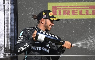 SILVERSTONE CIRCUIT, UNITED KINGDOM - JULY 18: Sir Lewis Hamilton, Mercedes, 1st position, sprays the victory Champagne during the British GP at Silverstone Circuit on Sunday July 18, 2021 in Northamptonshire, United Kingdom. (Photo by Mark Sutton / Sutton Images)
