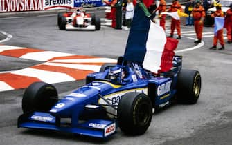 MONTE CARLO, MONACO - MAY 19: Olivier Panis, Ligier JS43 Mugen-Honda, carries the French flag on a lap of honour after winning the race during the Monaco GP at Monte Carlo on May 19, 1996 in Monte Carlo, Monaco. (Photo by LAT Images)