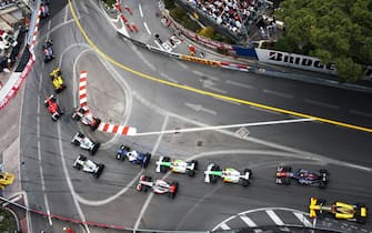 1303050453 Australian Red Bull Racing Formula One driver Mark Webber driving his RB6 racing car leads the field of cars and drivers through Sainte Devote corner watched by spectators, fans and crowd and circuit safety workers on lap one of the 2010 Monaco Grand Prix, Monte Carlo, on the 16 May 2010. (Photo by Darren Heath/Getty Images)