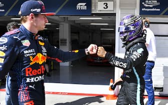 Formula 1 2021: Hungarian GP HUNGARORING, HUNGARY - JULY 31: Pole man Sir Lewis Hamilton, Mercedes, fist bumbs Max Verstappen, Red Bull Racing, in Parc Ferme after Qualifying during the Hungarian GP at Hungaroring on Saturday July 31, 2021 in Budapest, Hungary. (Photo by Mark Sutton / Sutton Images)