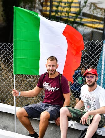 AUTODROMO NAZIONALE MONZA, ITALY - SEPTEMBER 10: A fan with an Italian flag in a grandstand during the Italian GP at Autodromo Nazionale Monza on Friday September 10, 2021 in Monza, Italy. (Photo by Mark Sutton / Sutton Images)