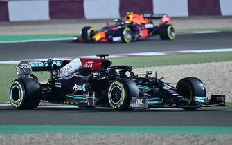 Mercedes' British driver Lewis Hamilton (foreground) drives during the second practice session ahead of the Qatari Formula One Grand Prix at the Losail International Circuit, in the city of Lusail, on November 19, 2021. (Photo by ANDREJ ISAKOVIC / AFP) (Photo by ANDREJ ISAKOVIC/AFP via Getty Images)