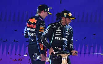 JEDDAH STREET CIRCUIT, SAUDI ARABIA - DECEMBER 05: Max Verstappen, Red Bull Racing, 2nd position, Sir Lewis Hamilton, Mercedes, 1st position, and Valtteri Bottas, Mercedes, 3rd position, celebrate during the Saudi Arabia GP  at Jeddah Street Circuit on Sunday December 05, 2021 in Jeddah, Saudi Arabia. (Photo by Mark Sutton / Sutton Images)