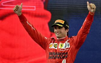 Third-placed Ferrari's Spanish driver Carlos Sainz Jr celebrates on the podium of the Yas Marina Circuit after the Abu Dhabi Formula One Grand Prix on December 12, 2021. - Max Verstappen became the first Dutchman ever to win the Formula One world championship title when he won a dramatic season-ending Abu Dhabi Grand Prix. (Photo by ANDREJ ISAKOVIC / AFP) (Photo by ANDREJ ISAKOVIC/AFP via Getty Images)