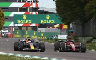 AUTODROMO INTERNAZIONALE ENZO E DINO FERRARI, ITALY - APRIL 23: Charles Leclerc, Ferrari F1-75, passes Max Verstappen, Red Bull Racing RB18, for the lead during the Emilia Romagna GP at Autodromo Internazionale Enzo e Dino Ferrari on Saturday April 23, 2022 in imola, Italy. (Photo by Zak Mauger / LAT Images)