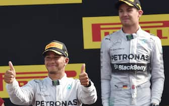 British Formula One driver Lewis Hamilton (L) of Mercedes AMG GP reacts on the podium after winning  the Formula One Grand  in Monza ahead his teammate German Formula One driver Nico Rosberg, Monza, Italy, 7 September 2014. ANSA/DANIEL DAL ZENNARO