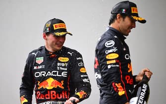 IMOLA, ITALY - APRIL 24: Race winner Max Verstappen of the Netherlands and Oracle Red Bull Racing and Second placed Sergio Perez of Mexico and Oracle Red Bull Racing celebrate on the podium during the F1 Grand Prix of Emilia Romagna at Autodromo Enzo e Dino Ferrari on April 24, 2022 in Imola, Italy. (Photo by Clive Mason/Getty Images)