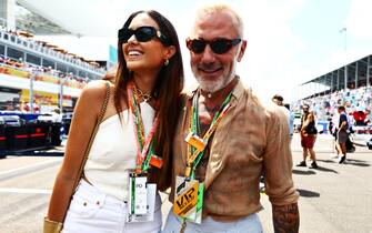 MIAMI, FLORIDA - MAY 08: Sharon Fonseca and Gianluca Vacchi pose for a photo on the grid during the F1 Grand Prix of Miami at the Miami International Autodrome on May 08, 2022 in Miami, Florida. (Photo by Mark Thompson/Getty Images)
