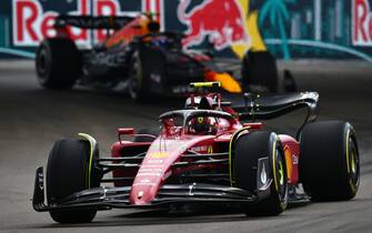 MIAMI, FLORIDA - MAY 08: Carlos Sainz of Spain driving (55) the Ferrari F1-75 leads Sergio Perez of Mexico driving the (11) Oracle Red Bull Racing RB18 on track during the F1 Grand Prix of Miami at the Miami International Autodrome on May 08, 2022 in Miami, Florida. (Photo by Clive Mason - Formula 1/Formula 1 via Getty Images)