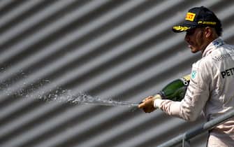 Spa-Francorchamps, Spa, Belgium.Sunday 28 August 2016.Lewis Hamilton, Mercedes AMG, 3rd Position, sprays Champagne from the podium.World Copyright: Zak Mauger/LAT Photographicref: Digital Image _X0W3537