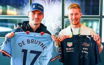 SPA, BELGIUM - AUGUST 28: Max Verstappen of the Netherlands and Oracle Red Bull Racing meets Kevin de Bruyne in the Paddock prior to  the F1 Grand Prix of Belgium at Circuit de Spa-Francorchamps on August 28, 2022 in Spa, Belgium. (Photo by Mark Thompson/Getty Images)