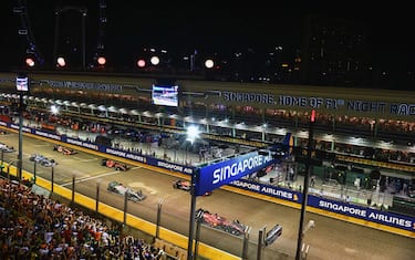 MARINA BAY STREET CIRCUIT, SINGAPORE - OCTOBER 02: Charles Leclerc, Ferrari F1-75, Sergio Perez, Red Bull Racing RB18, Sir Lewis Hamilton, Mercedes W13, and Carlos Sainz, Ferrari F1-75, lead the field away for the formation lap during the Singapore GP at Marina Bay Street Circuit on Sunday October 02, 2022 in Singapore, Singapore. (Photo by Simon Galloway / LAT Images)
