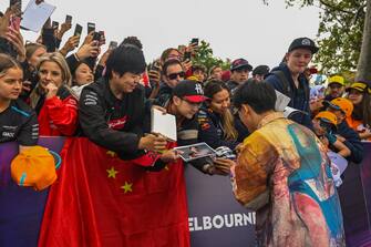 MELBOURNE GRAND PRIX CIRCUIT, AUSTRALIA - MARCH 30: Zhou Guanyu, Alfa Romeo F1 Team with fans on the Melbourne Walk during the Australian GP at Melbourne Grand Prix Circuit on Thursday March 30, 2023 in Melbourne, Australia. (Photo by Simon Galloway / LAT Images)