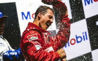 HOCKENHEIMRING, GERMANY - DECEMBER 21: Michael Schumacher, 1st position, celebrates victory on the podium with Juan Pablo Montoya, 2nd position during the German GP at Hockenheimring on December 21, 2017 in Hockenheimring, Germany. (Photo by LAT Images)
