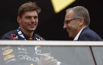 CIRCUIT GILLES-VILLENEUVE, CANADA - JUNE 18: Max Verstappen, Red Bull Racing, 1st position, is congratulated on the podium by Stefano Domenicali, CEO, Formula 1 during the Canadian GP at Circuit Gilles-Villeneuve on Sunday June 18, 2023 in Montreal, Canada. (Photo by Zak Mauger / LAT Images)