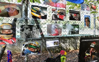 A picture shows pictures displayed near the Ayrton Senna memorial monument in the the mineral water park near the Enzo et Dino Ferrari Autodromo in Imola, on October 31, 2020, a day ahead of the Formula One Emilia Romagna Grand Prix. (Photo by JENNIFER LORENZINI / POOL / AFP) (Photo by JENNIFER LORENZINI/POOL/AFP via Getty Images)