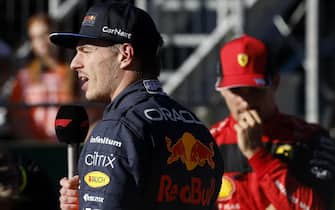 Pole position winner Red Bull Racing's Dutch driver Max Verstappen (L) delivers a speech next to second placed Ferrari's Monegasque driver Charles Leclerc after the qualifying session at the Red Bull Ring race track in Spielberg, Austria, on July 8, 2022, ahead of the Formula One Austrian Grand Prix. - Austria OUT (Photo by ERWIN SCHERIAU / APA / AFP) / Austria OUT (Photo by ERWIN SCHERIAU/APA/AFP via Getty Images)
