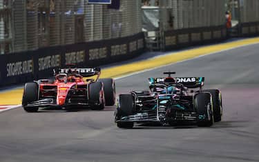 MARINA BAY STREET CIRCUIT, SINGAPORE - SEPTEMBER 17: George Russell, Mercedes F1 W14, leads Charles Leclerc, Ferrari SF-23 during the Singapore GP at Marina Bay Street Circuit on Sunday September 17, 2023 in Singapore, Singapore. (Photo by Steve Etherington / LAT Images)