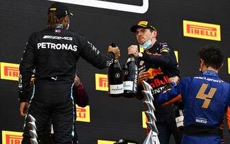 AUTODROMO INTERNAZIONALE ENZO E DINO FERRARI, ITALY - APRIL 18: Sir Lewis Hamilton, Mercedes, 2nd position, Max Verstappen, Red Bull Racing, 1st position, and Lando Norris, McLaren, 3rd position, congratulate each other on the podium during the Emilia Romagna GP at Autodromo Internazionale Enzo e Dino Ferrari on Sunday April 18, 2021 in imola, Italy. (Photo by Mark Sutton / Sutton Images)