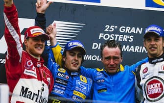 IMOLA, ITALY - APRIL 24: Fernando Alonso, 1st position, celebrates on the podium with Michael Schumacher, 2nd position, Jenson Button, 3rd position but later disqualified, and Bob Bell during the San Marino GP at Imola on April 24, 2005 in Imola, Italy. (Photo by LAT Images)