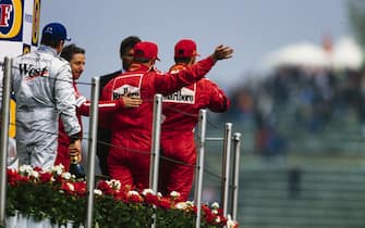 IMOLA, ITALY - APRIL 20: Michael Schumacher, 1st position, Kimi RÃ¤ikkÃ¶nen, 2nd position, Rubens Barrichello, 3rd position, and Jean Todt leave the podium during the San Marino GP at Imola on April 20, 2003 in Imola, Italy. (Photo by LAT Images)
