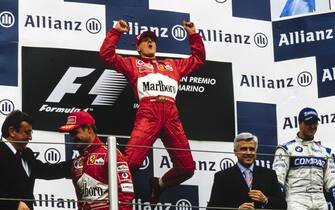 IMOLA, ITALY - APRIL 14: Michael Schumacher, 1st position, leaps in celebration on the podium alongside Rubens Barrichello, 2nd position, and Ralf Schumacher, 3rd position during the San Marino GP at Imola on April 14, 2002 in Imola, Italy. (Photo by LAT Images)