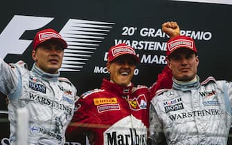 IMOLA, ITALY - APRIL 09: Mika HÃ¤kkinen, 2nd position, Michael Schumacher, 1st position, and David Coulthard, 3rd position, on the podium during the San Marino GP at Imola on April 09, 2000 in Imola, Italy. (Photo by LAT Images)