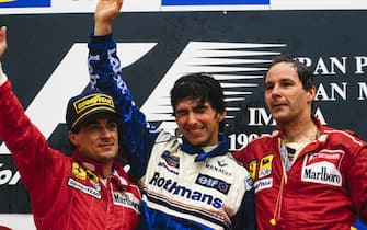 IMOLA, ITALY - APRIL 30: Jean Alesi, 2nd position, Damon Hill, 1st position, and Gerhard Berger, 3rd position, celebrate on the podium during the San Marino GP at Imola on April 30, 1995 in Imola, Italy. (Photo by LAT Images)