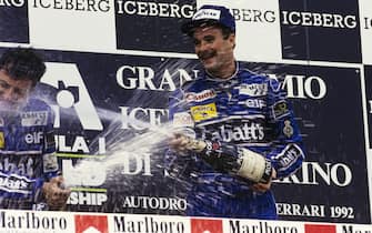 IMOLA, ITALY - MAY 17: Nigel Mansell, 1st position, sprays champagne as he celebrates on the podium with Riccardo Patrese, 2nd position during the San Marino GP at Imola on May 17, 1992 in Imola, Italy. (Photo by LAT Images)