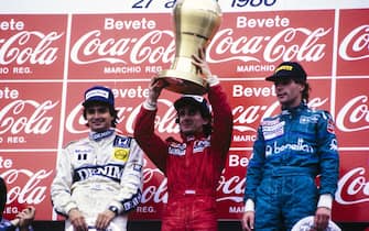IMOLA, ITALY - APRIL 27: Nelson Piquet, 2nd position, Alain Prost, 1st position, and Gerhard Berger, 3rd position, on the podium during the San Marino GP at Imola on April 27, 1986 in Imola, Italy. (Photo by Ercole Colombo / Studio Colombo)
