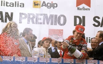 Imola, Italy.23-25 April 1982.Didier Pironi (Ferrari) 1st position celebrates on the podium with teammate Gilles Villeneuve 2nd position behind.Ref-82 SM 02.World Copyright - LAT Photographic