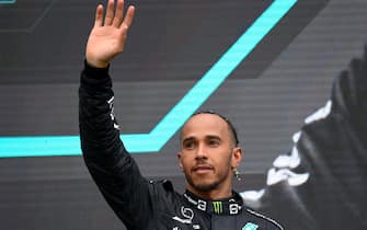 epa10100299 Second placed Mercedes driver Lewis Hamilton of Britain reacts on the podium after the Formula One Grand Prix of Hungary at the Hungaroring circuit in Mogyorod, near Budapest, Hungary, 31 July 2022.  EPA/Zsolt Czegledi HUNGARY OUT