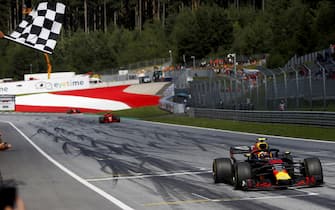 RED BULL RING, AUSTRIA - JULY 01: Max Verstappen, Red Bull Racing RB14 Tag Heuer, takes the chequered flag ahead of Kimi Raikkonen, Ferrari SF71H, and Sebastian Vettel, Ferrari SF71H during the Austrian GP at Red Bull Ring on July 01, 2018 in Red Bull Ring, Austria. (Photo by Glenn Dunbar / LAT Images)