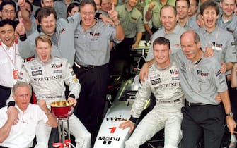 01/11/98 - Japanese Grand Prix.
Mika Hakkinen and David Coulthard celebrate with the Mercedes McLaren team after they won the Constructors Championship.
Pic Steve Etherington.