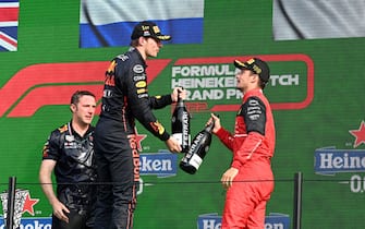 CIRCUIT ZANDVOORT, NETHERLANDS - SEPTEMBER 04: Max Verstappen, Red Bull Racing, 1st position, and Charles Leclerc, Ferrari, 3rd position, congratulate each other on the podium during the Dutch GP at Circuit Zandvoort on Sunday September 04, 2022 in North Holland, Netherlands. (Photo by Mark Sutton / Sutton Images)